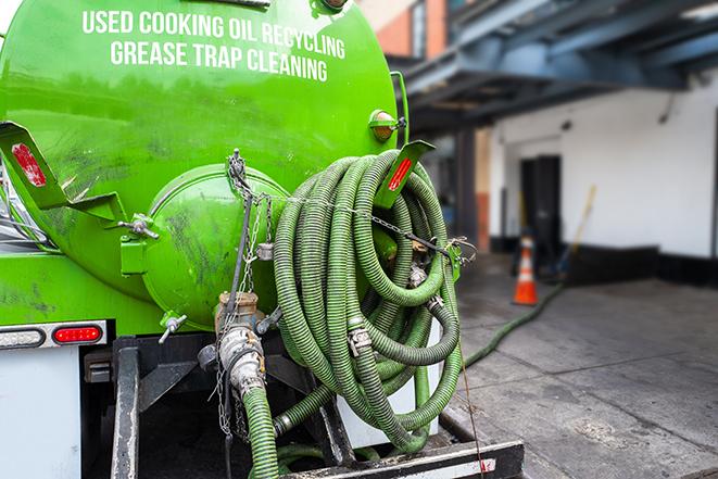 maintenance crew pumping grease trap at a fast food restaurant in Benton